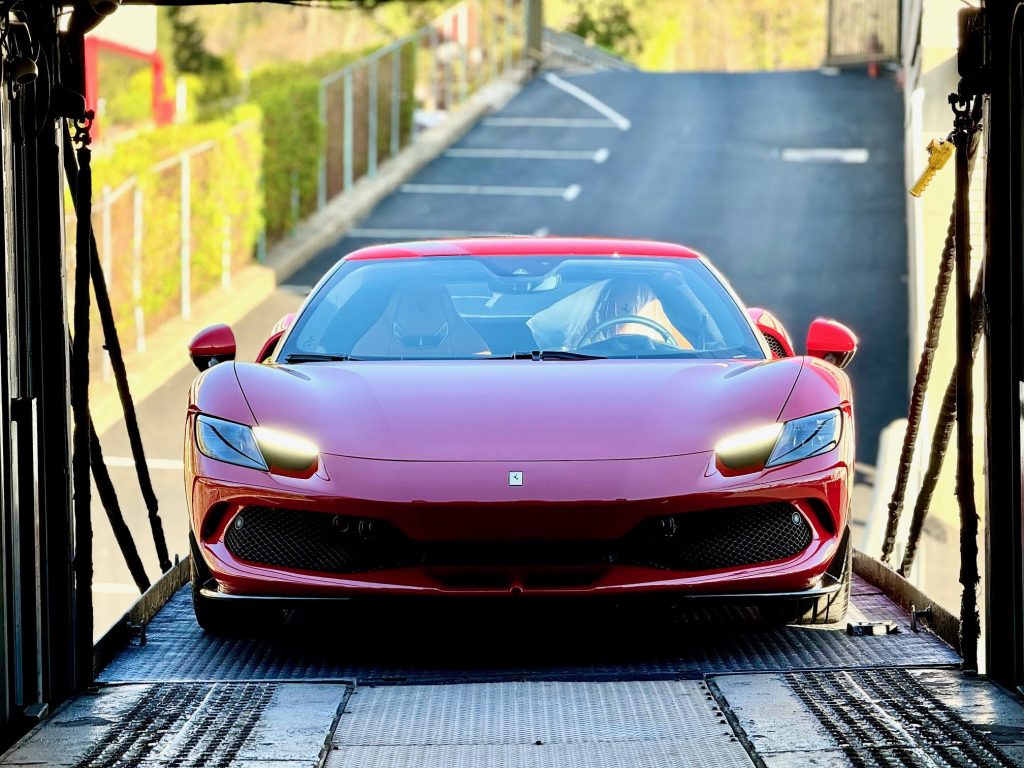 Enclosed auto transport of red Ferrari from Hamptons to Palm Beach with white-glove service