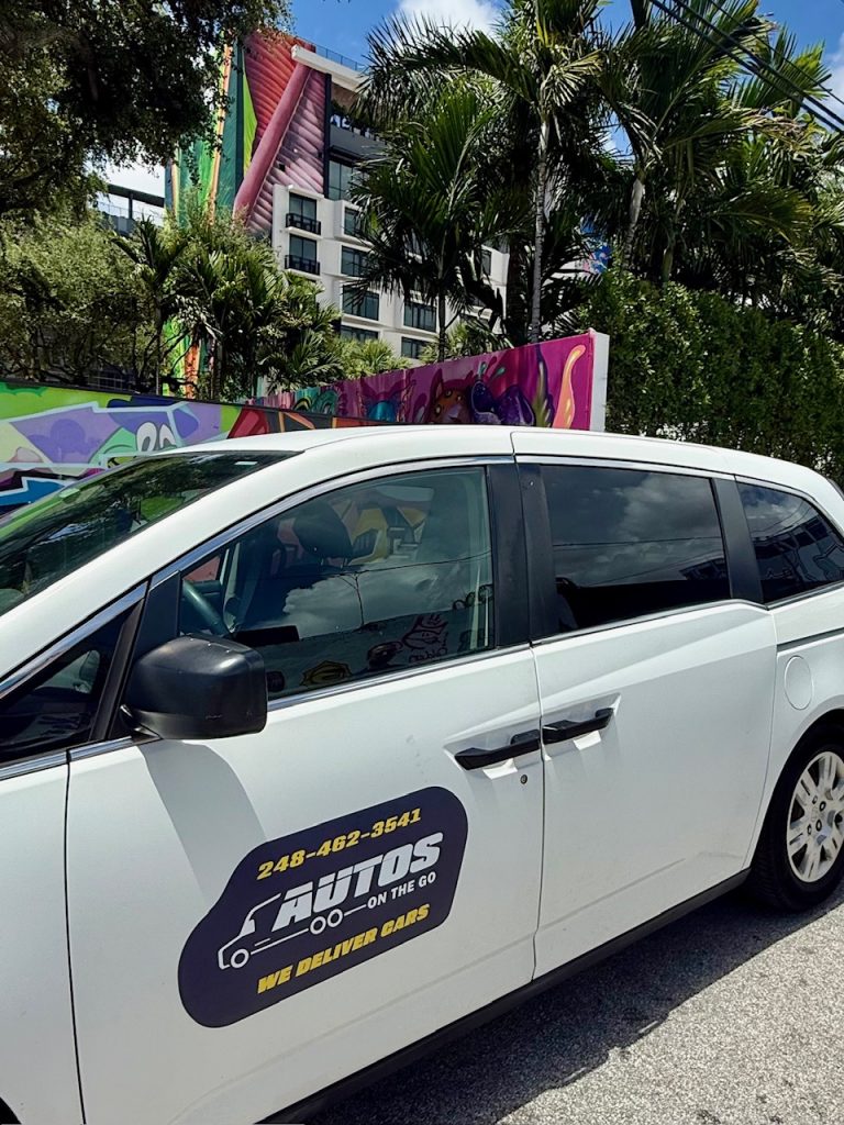 Autos On The Go delivery van with company logo and phone number, serving The Villages, Florida community.