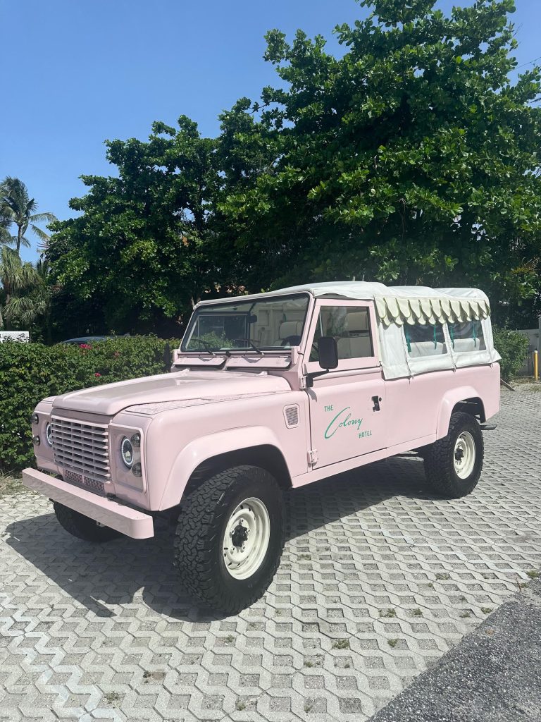 Classic Land Rover Defender 110 in pink, customized for The Colony Hotel, parked in Palm Beach